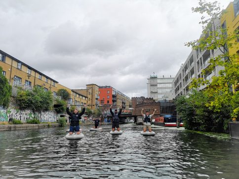Group of Guys Paddleboarding in Camden Town